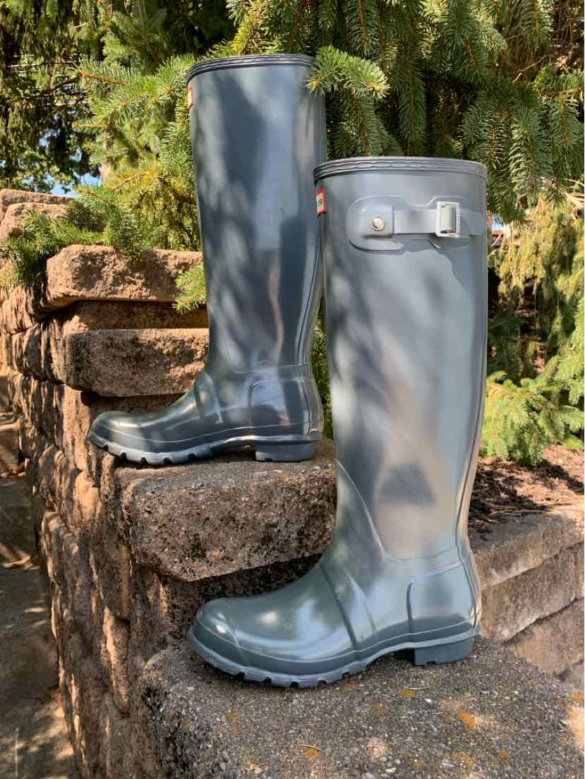 Matte gray knee-high rubber boots with adjustable side buckle and rugged tread soles, size 8.