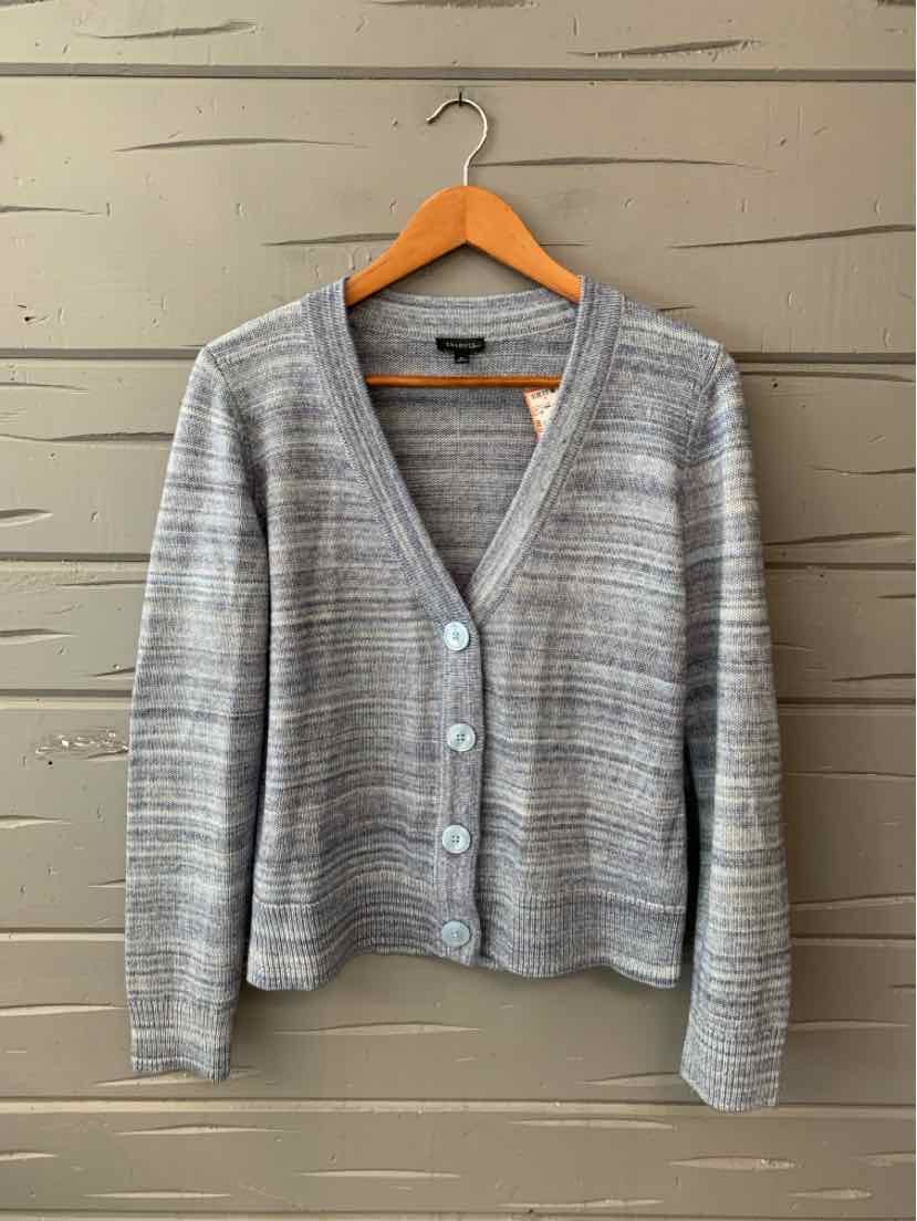 Light gray knitted cardigan with long sleeves, V-neck, and three front buttons hanging on wooden hanger.