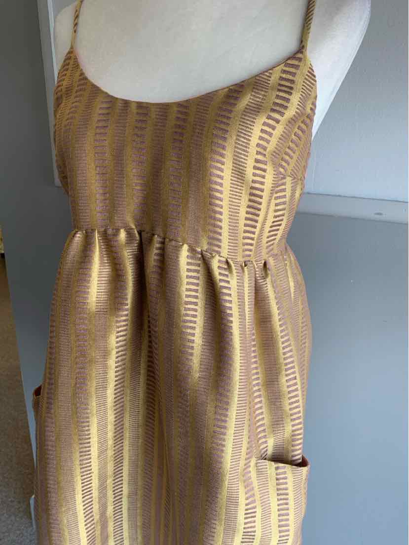 Gold jacquard sleeveless dress with thin straps and a gathered waist, size 8.
