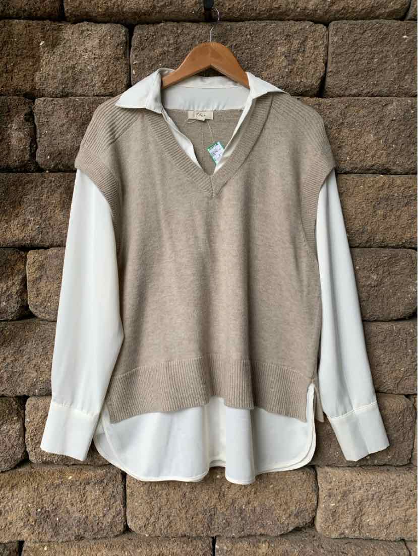Beige sleeveless knit vest layered over a white collared long-sleeve shirt with buttoned cuffs.