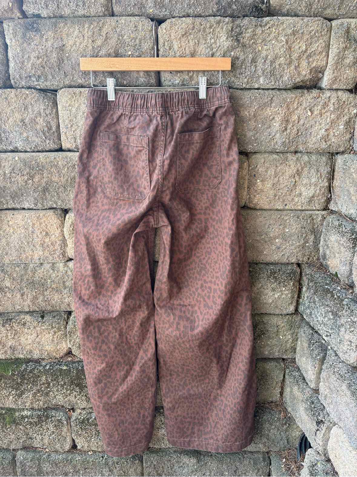 Women's GAP cheetah-print pants in brown and muted pink, with a loose fit and elastic waistband.