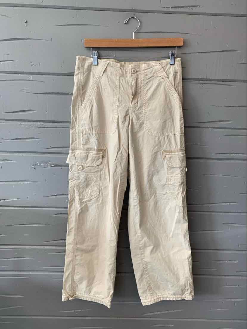 Tan cargo pants with multiple pockets and a relaxed fit, size 2, hanging on a wooden hanger.