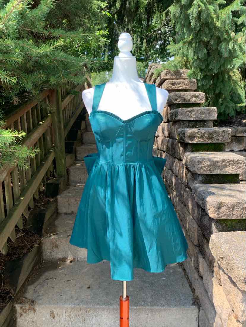Teal satin sleeveless fit-and-flare dress with sweetheart neckline and pleated skirt.