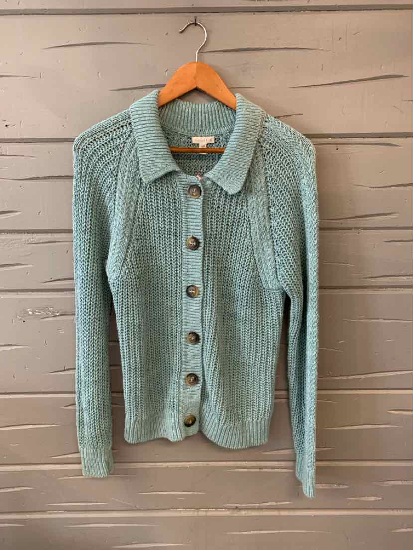Light blue button-up knit cardigan with ribbed texture and collar on wooden hanger.