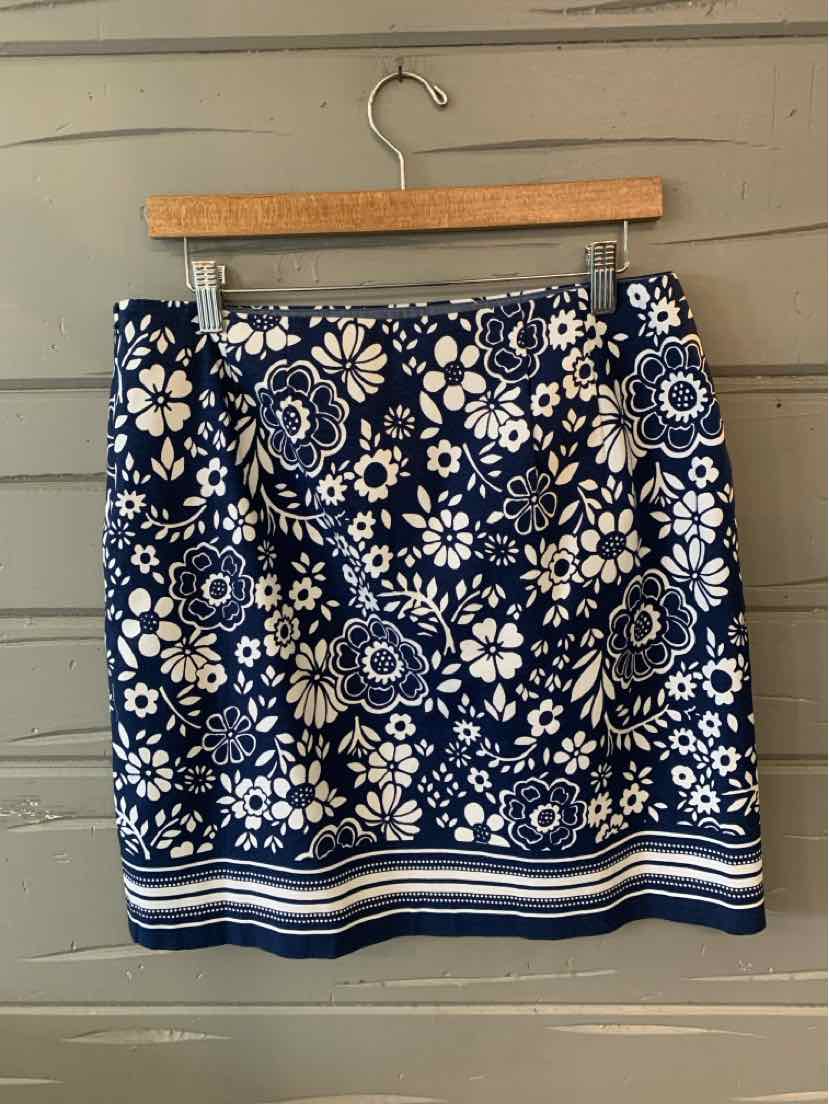 Navy blue skirt with white floral pattern and striped hem, size 10P.