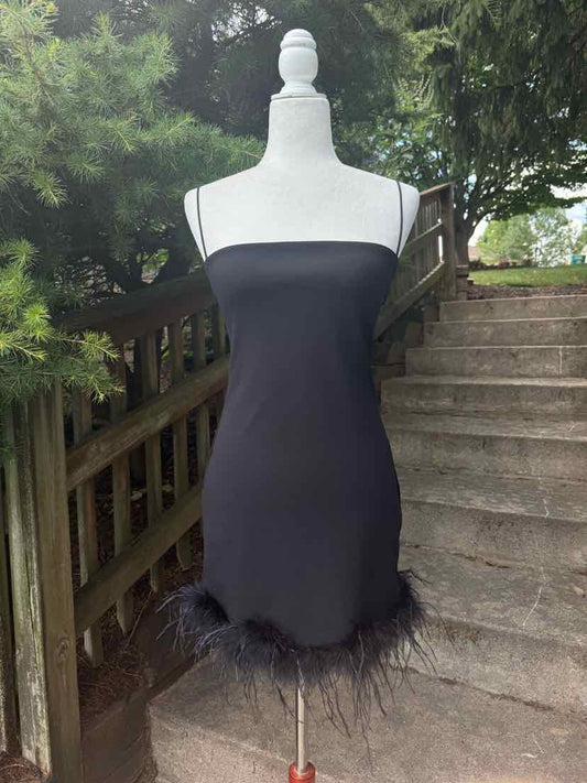Black sleeveless bodycon dress with feather trim at hem, fitted silhouette, and square neckline.