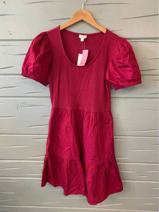 Burgundy short-sleeve dress with scoop neckline and tiered skirt on wooden hanger.