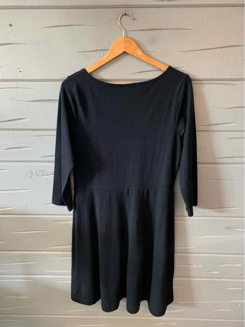 Black knee-length dress with three-quarter sleeves and a fitted waist on wooden hanger.