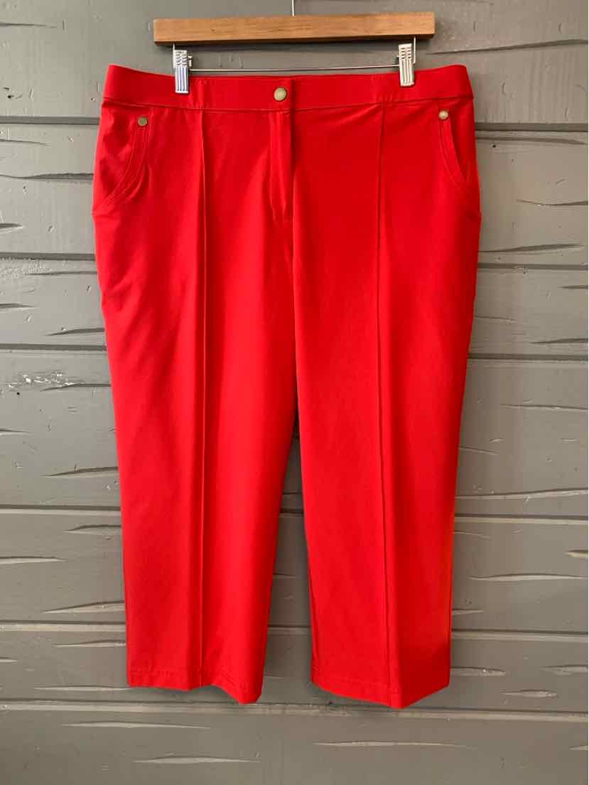 Red straight-leg pants with front pockets and belt loops, size 16/18, hanging on wooden hanger.