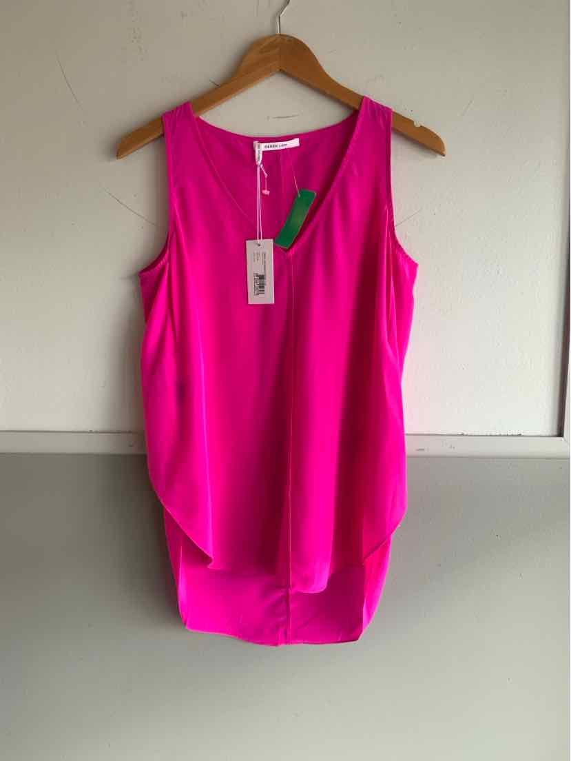 Sleeveless bright pink blouse with a round neckline and back zipper detail on wooden hanger.