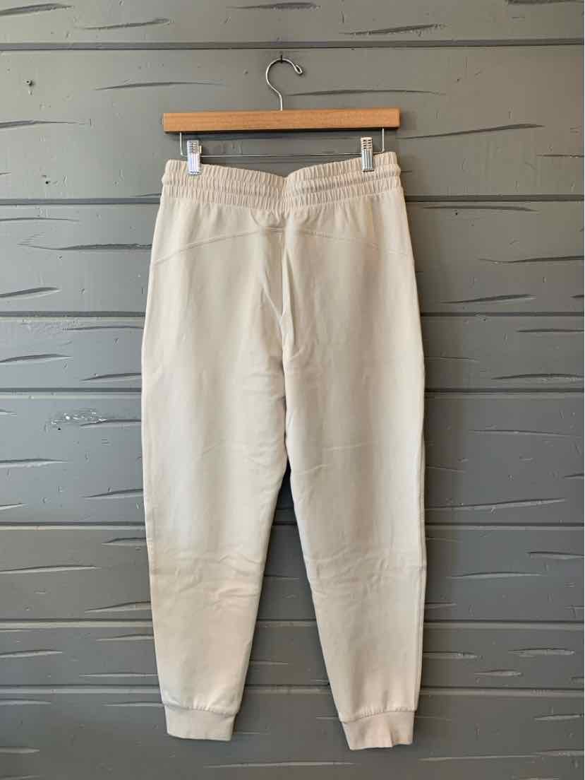 Light beige Old Navy jogger pants with an elastic waistband, side pockets, and ribbed ankle cuffs.
