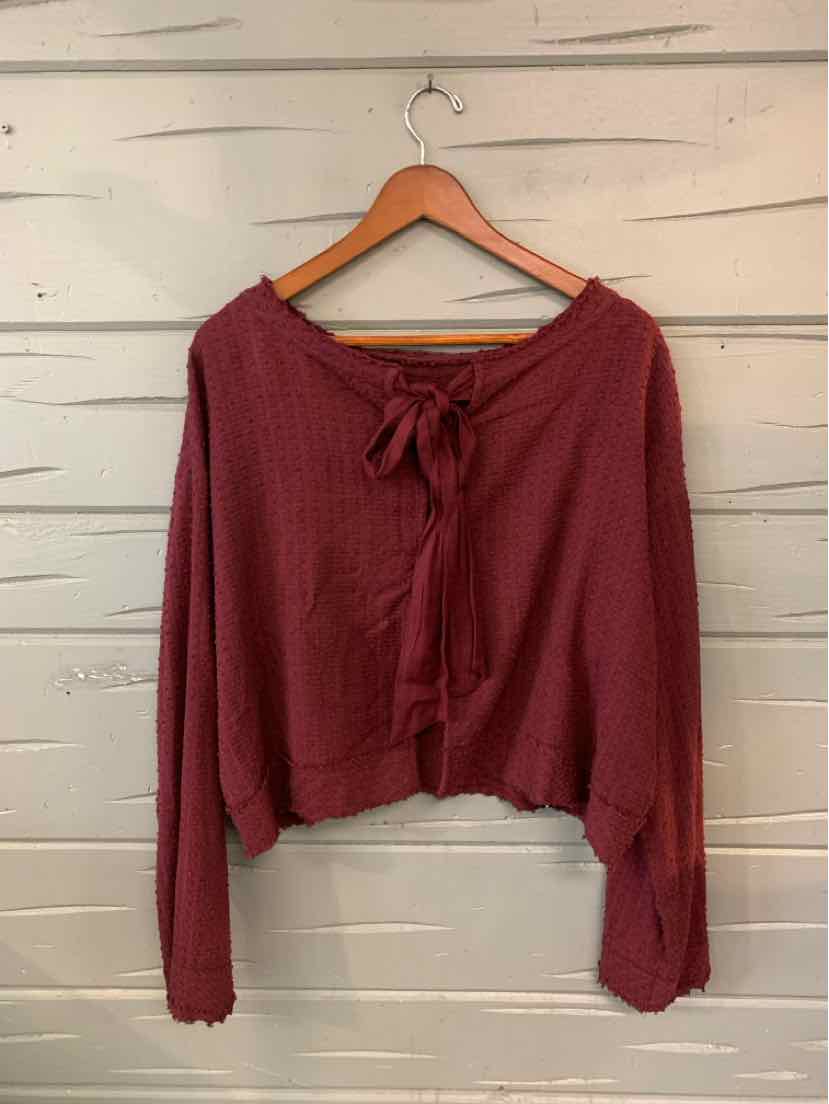 Long-sleeve burgundy knit top with cropped hem and front tie detail, size XS.