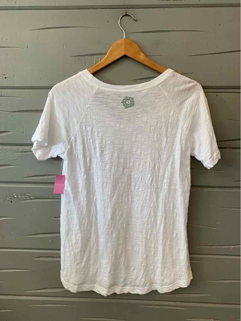 White short-sleeve crew neck t-shirt with a relaxed fit hanging on a wooden hanger against a gray wooden wall.