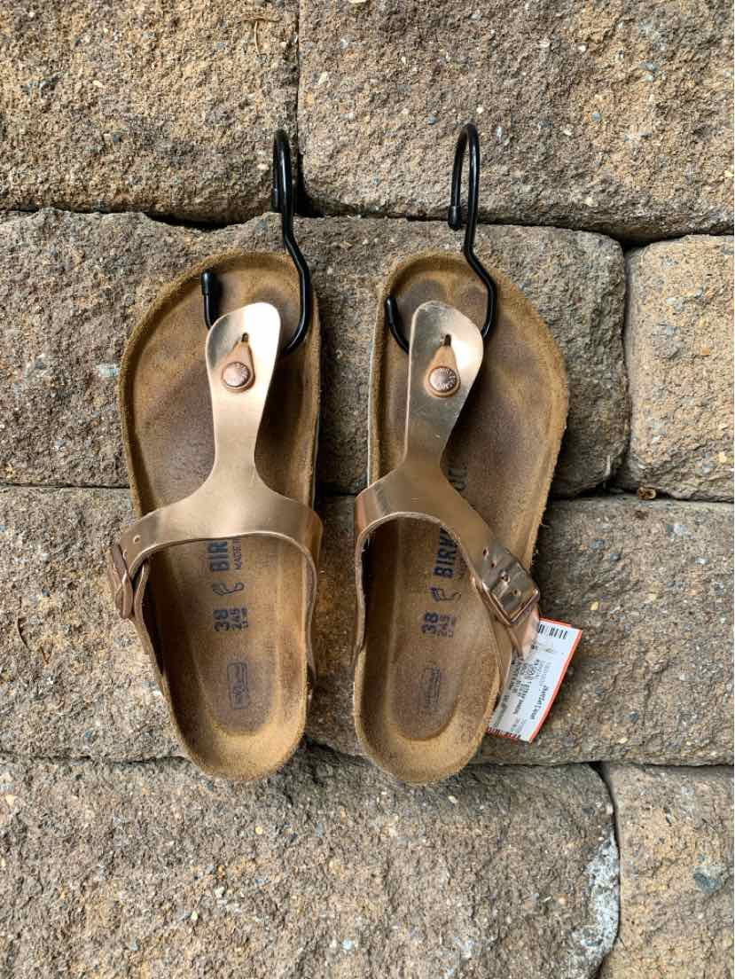 Metallic bronze Birkenstock RS sandals with adjustable toe strap and cork footbed, size 38.