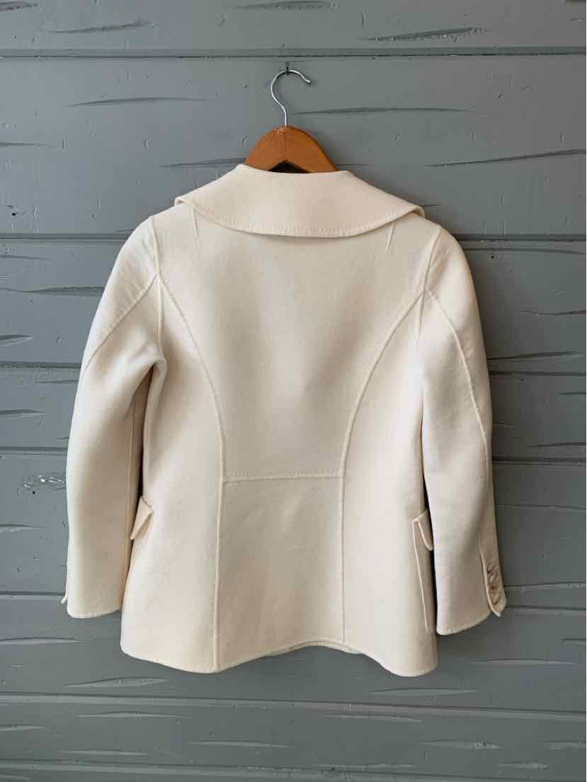 Cream-colored tailored blazer with structured seams and notch collar, size 4.