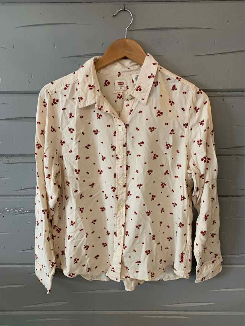 Cream long-sleeve button-up shirt with red floral print, size XL, hanging on wooden hanger.