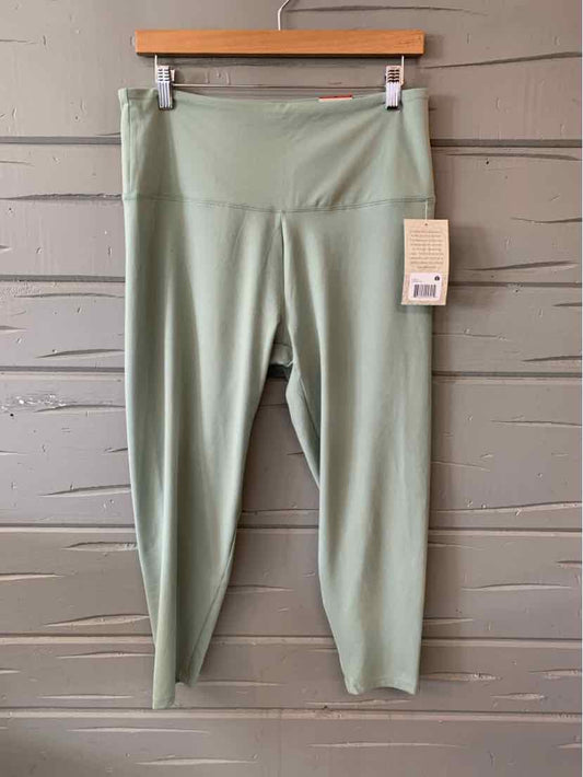 Sage green high-waist women's leggings with a wide waistband and tag attached, size XL.