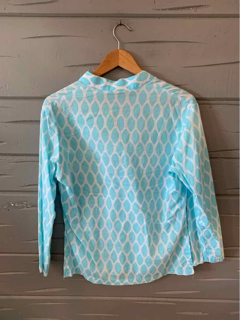 Light blue long-sleeve shirt with white geometric diamond pattern, medium size, hanging on wooden hanger.