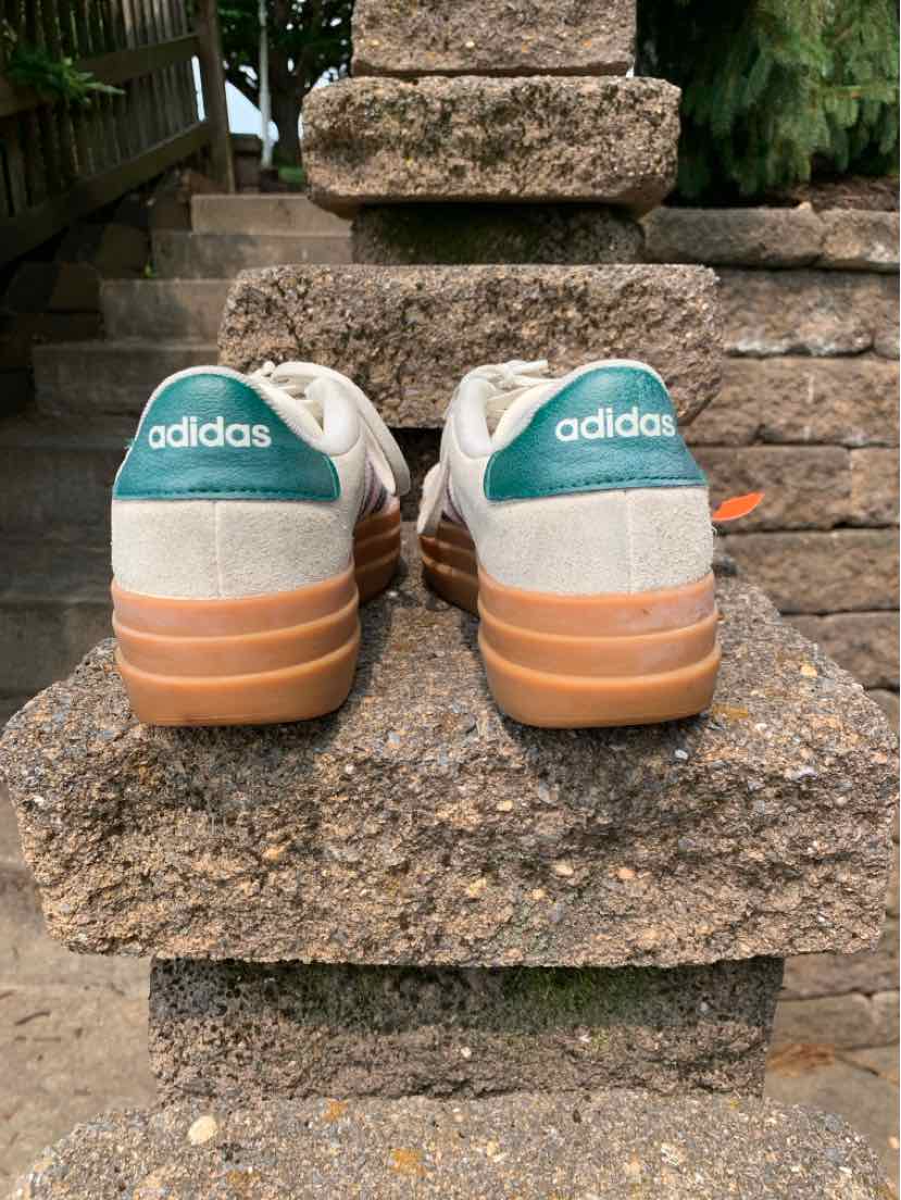 White Adidas sneakers with gum soles and teal Adidas logo patches on the heel, size 7.5.