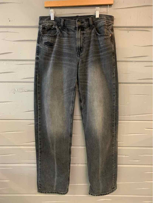 Black washed denim jeans in size 4 with a high waist and subtle fading on thighs.