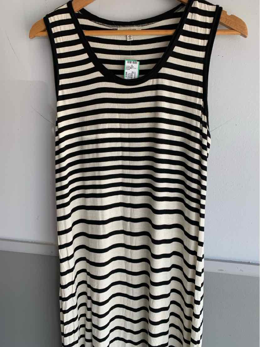 Black and white horizontal striped sleeveless dress in medium size hanging on wooden hanger.