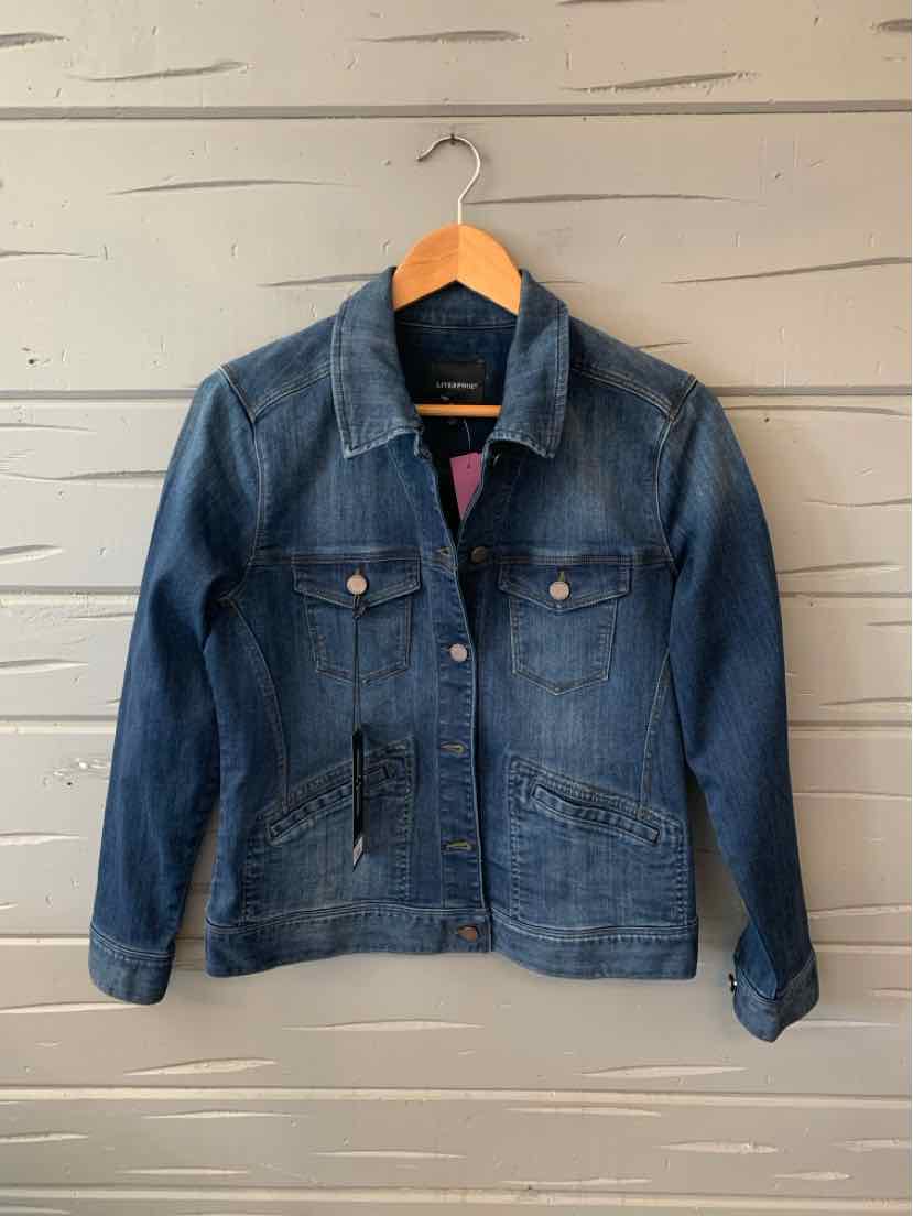 Medium blue denim jacket with button front, pointed collar, and chest pockets on wooden hanger.
