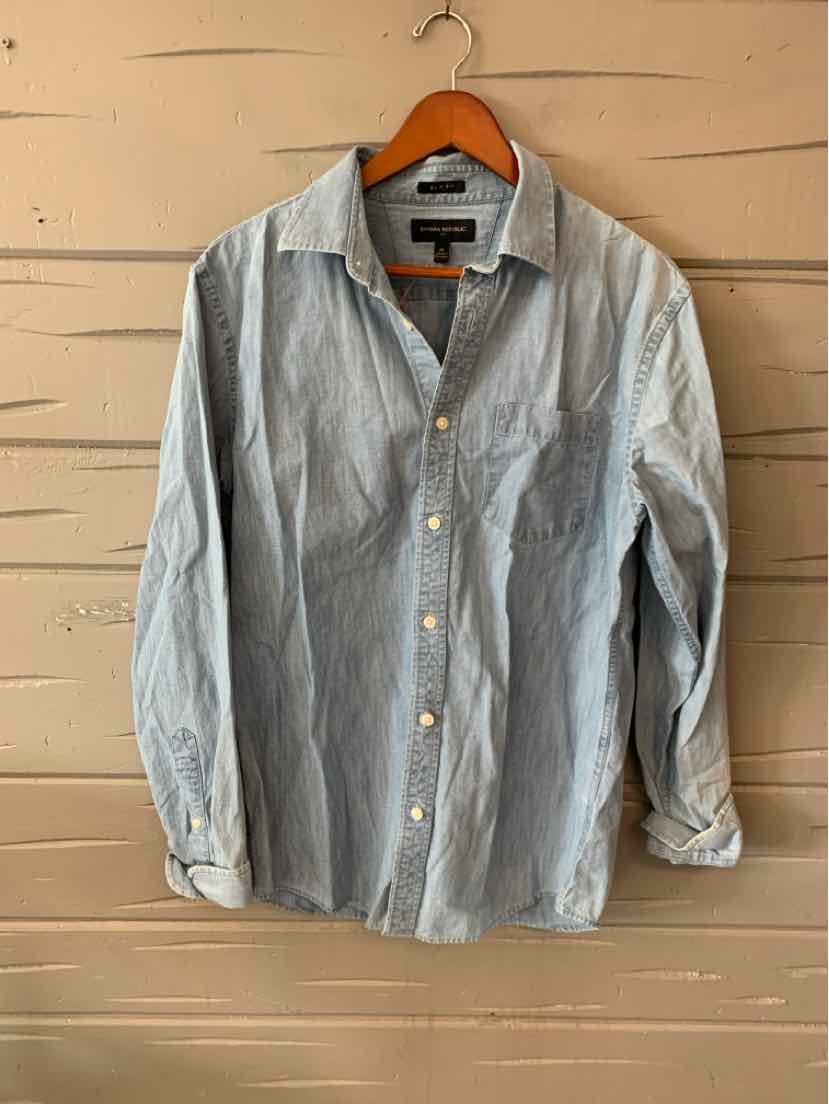 Light blue long-sleeve button-up shirt with collar, single chest pocket, and slightly wrinkled cotton fabric.