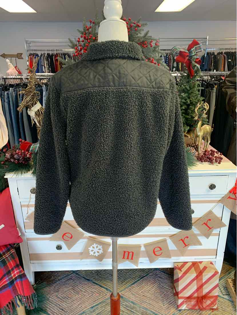 Dark gray textured fleece jacket with long sleeves and collar, displayed on mannequin in store setting.