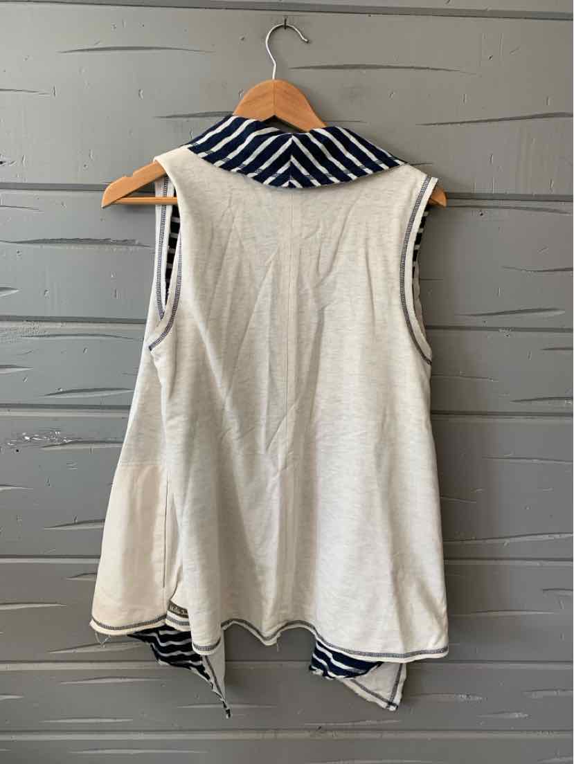 White sleeveless tunic with asymmetrical hem and navy blue striped collar.