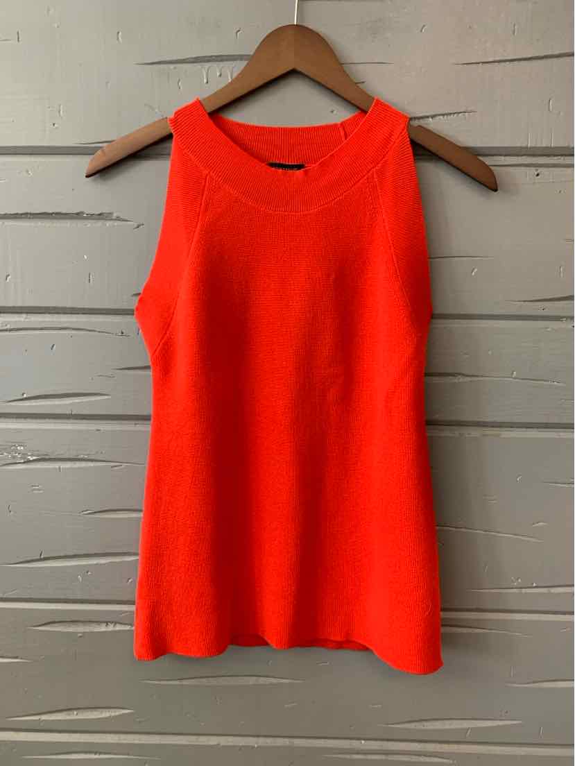 Bright red sleeveless knit top with scoop neckline hanging on wooden hanger.