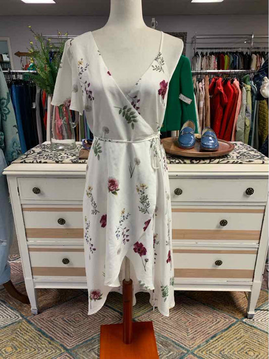 White midi wrap dress with pink and red floral print, V-neck, and sleeveless design.