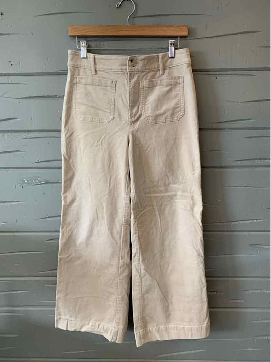 Tan high-waisted wide-leg pants with front patch pockets and belt loops, size 6P.