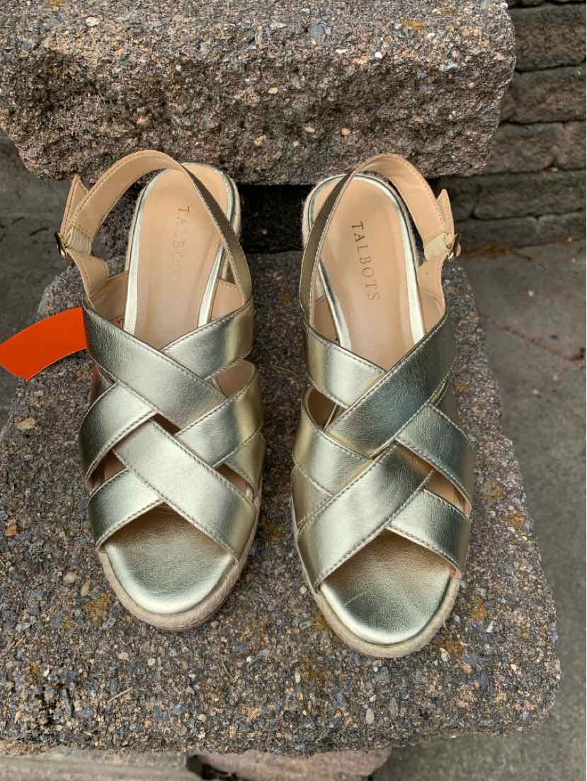 Metallic gold strappy sandal with crossed straps, ankle strap, and cushioned footbed in size 8.5.