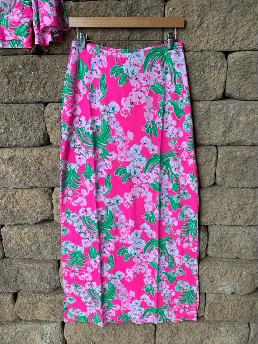 Pink tropical print wrap skirt with green and white floral pattern, midi length.