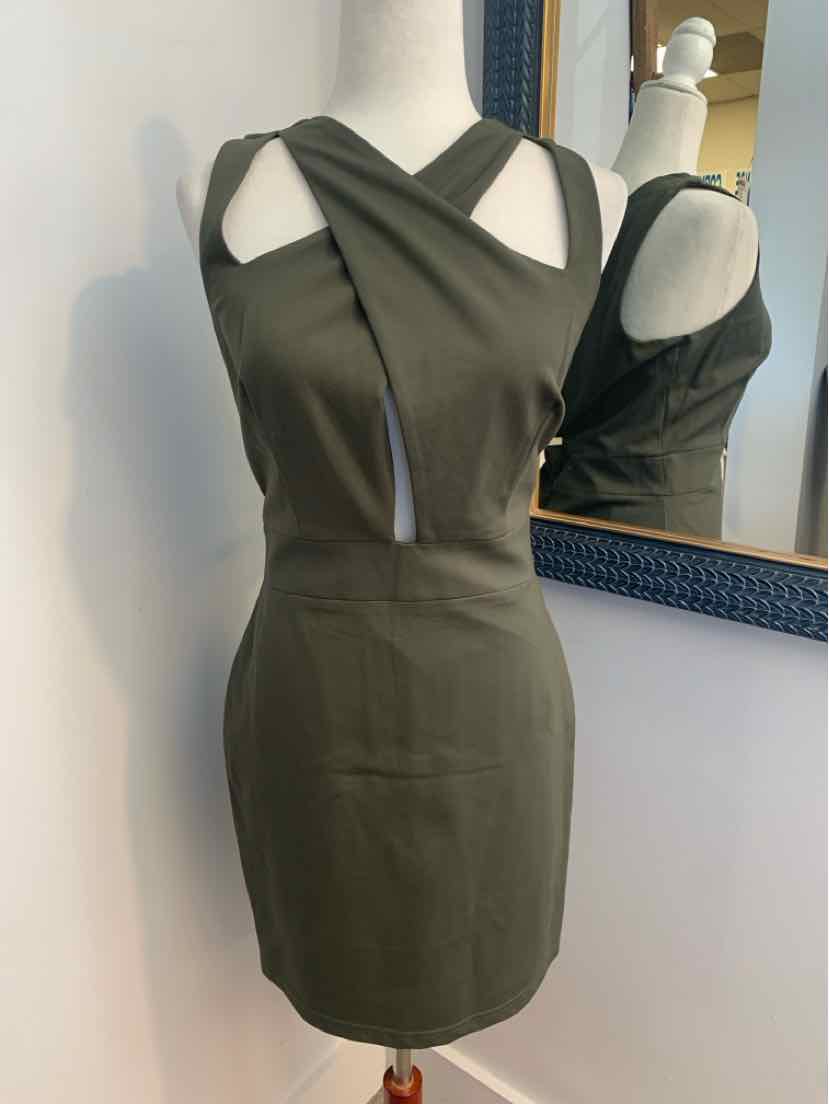 Sleeveless dark green fitted dress with crossed straps and square neckline.