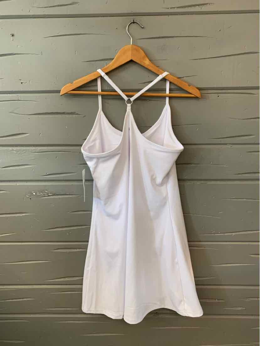 White sleeveless workout dress with racerback straps and A-line skirt hanging on wooden hanger.