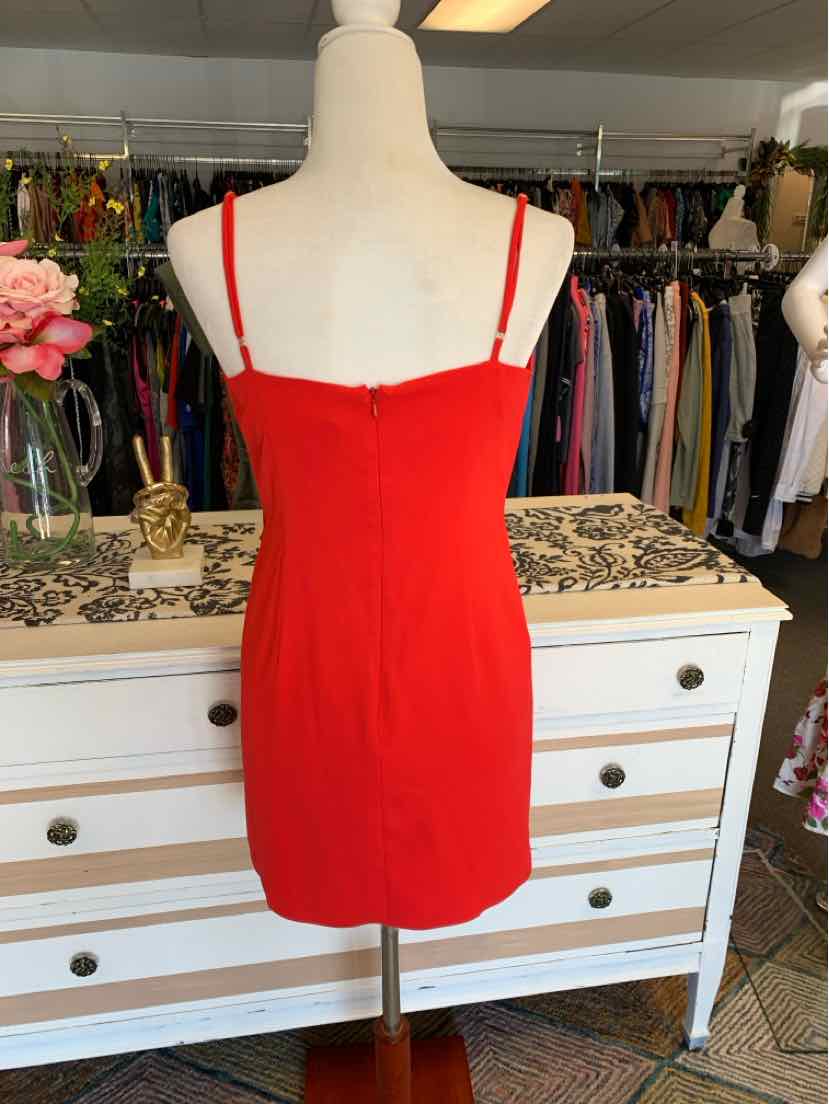 Red fitted mini dress with thin adjustable straps and straight neckline on mannequin.