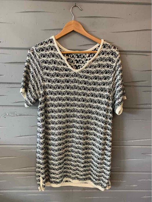 Light beige and black striped short-sleeve knit top with scoop neckline and relaxed fit on wooden hanger.