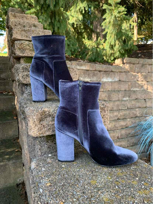 Pair of navy blue suede ankle boots with rounded toes and chunky block heels.