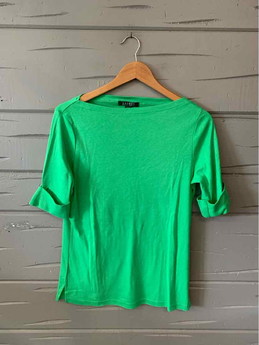Bright green long-sleeve shirt with rolled cuffs and a boat neckline on a wooden hanger.