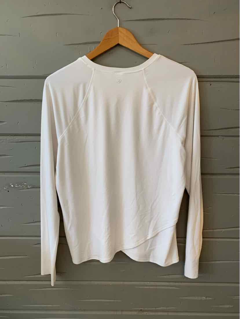 White long-sleeve lightweight athletic shirt with crew neck and slim fit on wooden hanger.