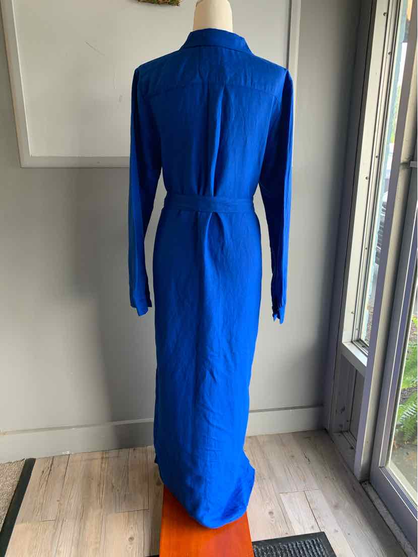 Long blue linen dress with long sleeves and a cinched waist tie, floor-length design.