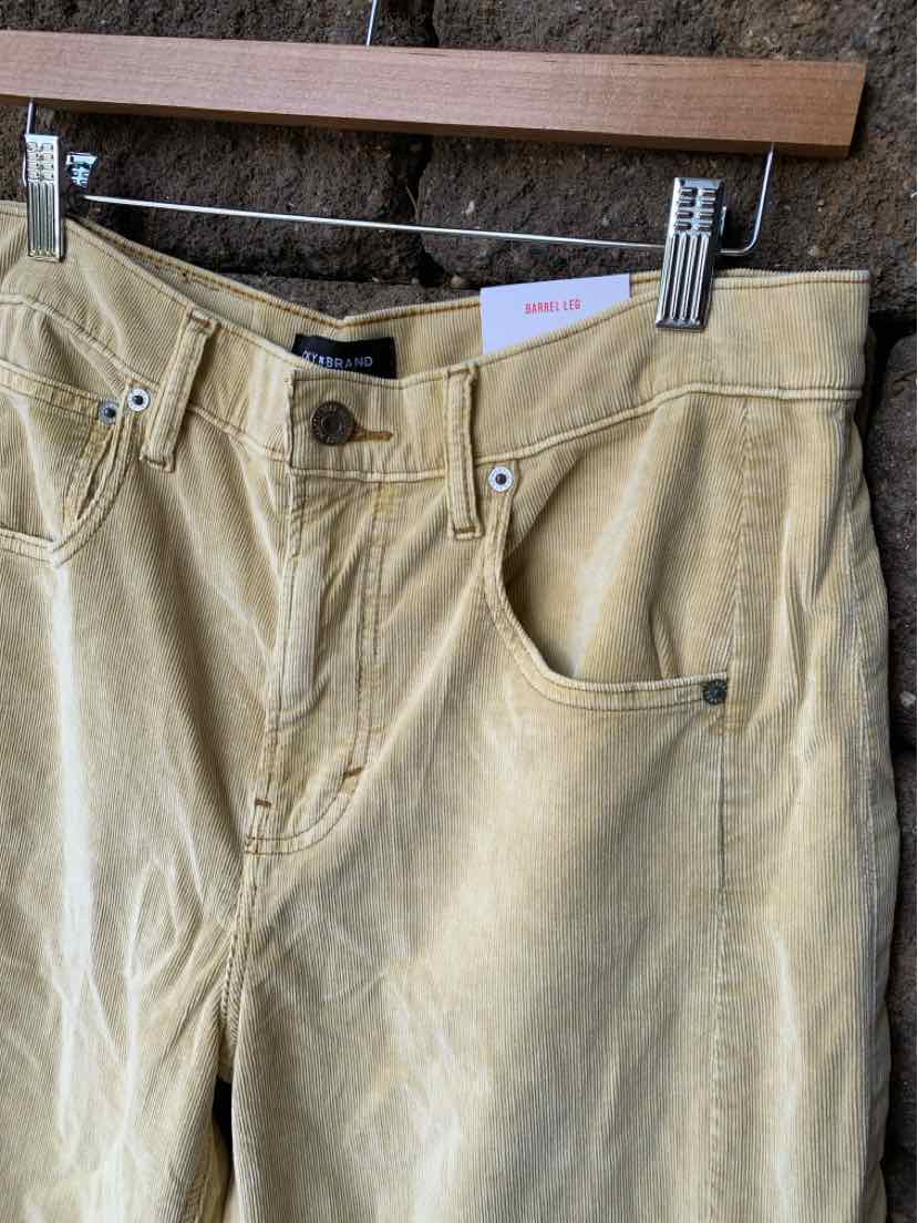 Tan corduroy pants with front button and zipper closure, side pockets, and belt loops, size 6.