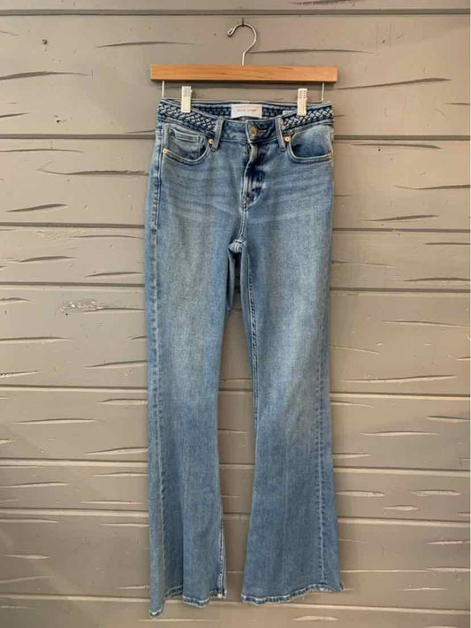Light blue denim jeans with high waist, button fly, and slight flare hem.
