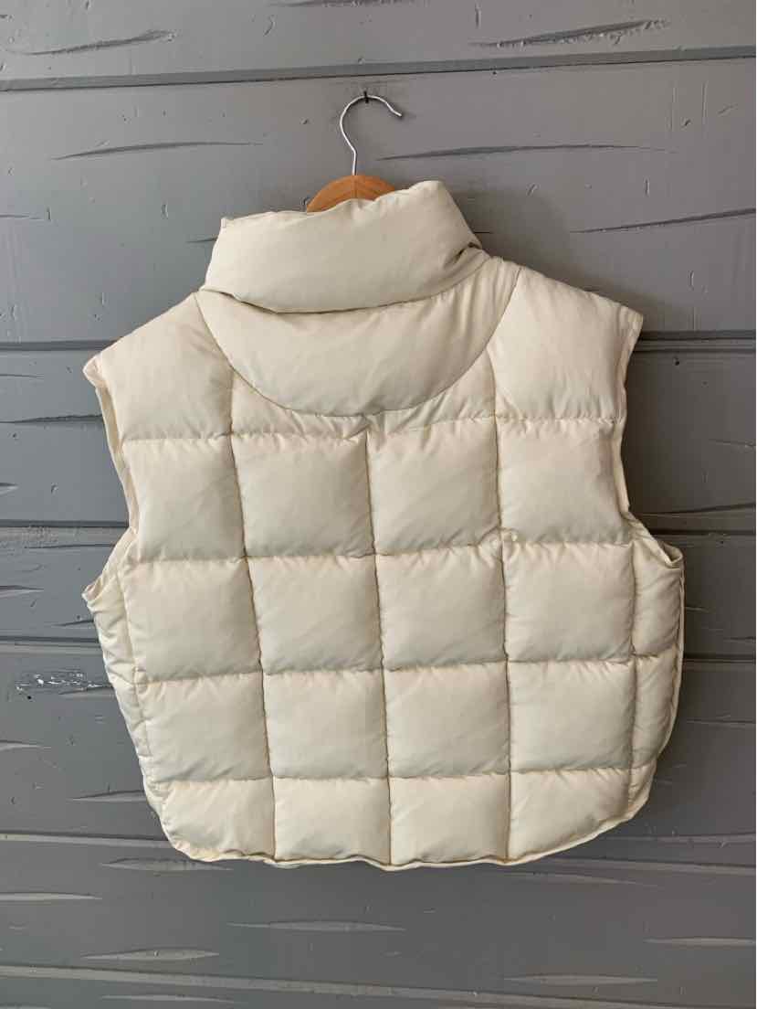 Cream-colored quilted puffer vest with high collar and boxy fit in size XS.
