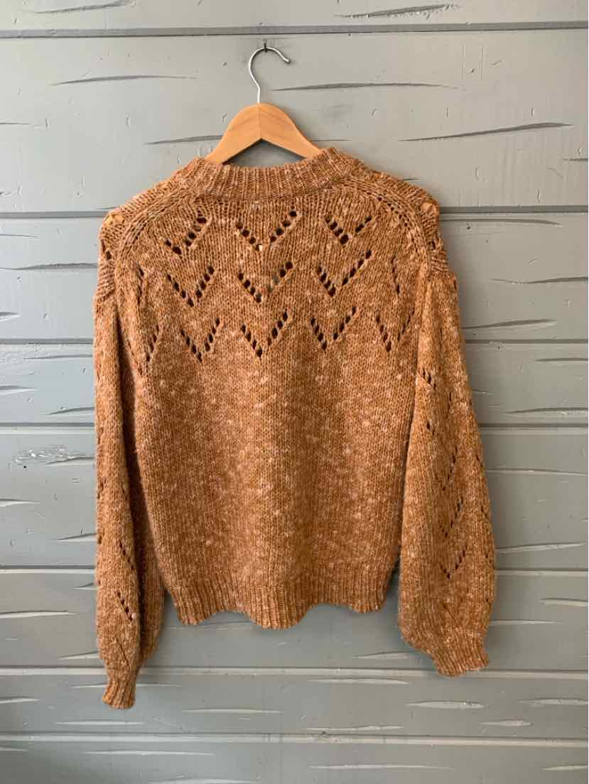 Light brown marled knit sweater with long sleeves and a chevron lace pattern on the back.