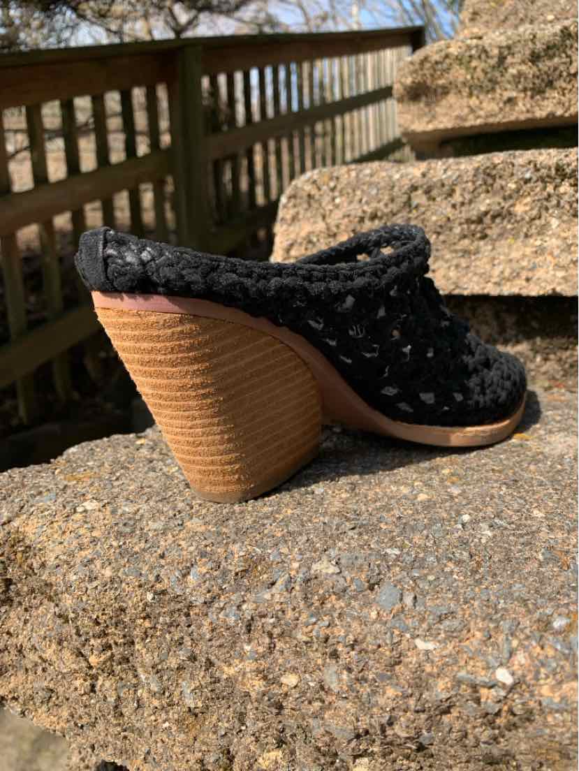Black woven mule shoe with a rounded toe and stacked wooden block heel size 9.