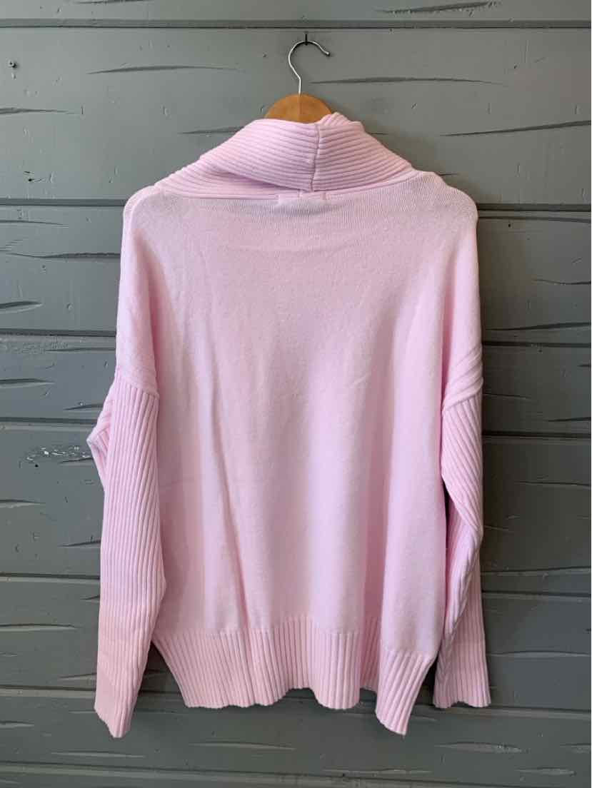 Light pink knit sweater with a high cowl neck, long sleeves, and ribbed hem and cuffs, shown from the back.
