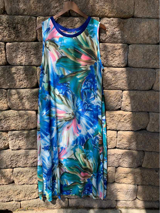 Sleeveless maxi dress with blue, green, and pink abstract floral print and navy trim neckline.