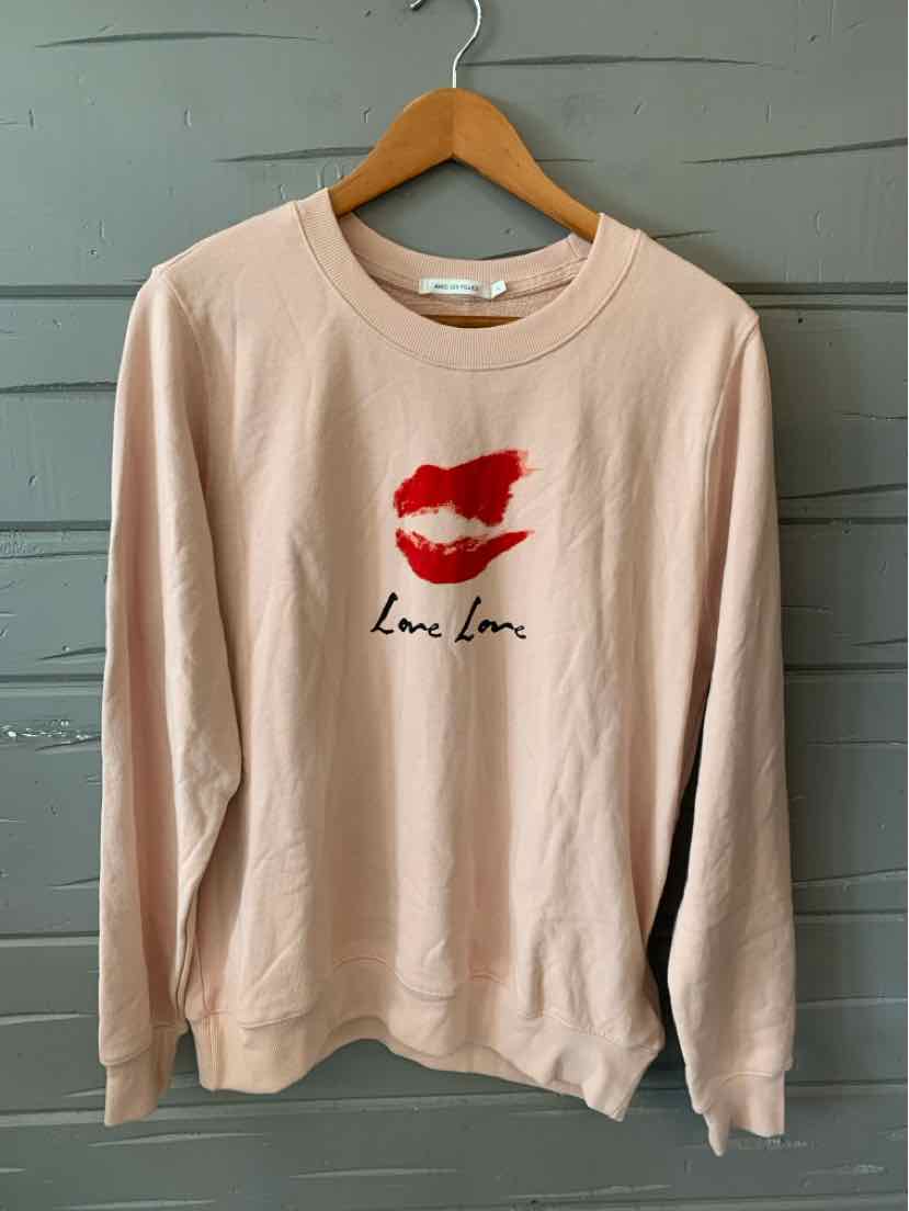 Light pink sweatshirt with red lip print and "love love" text on front, crew neck, long sleeves.